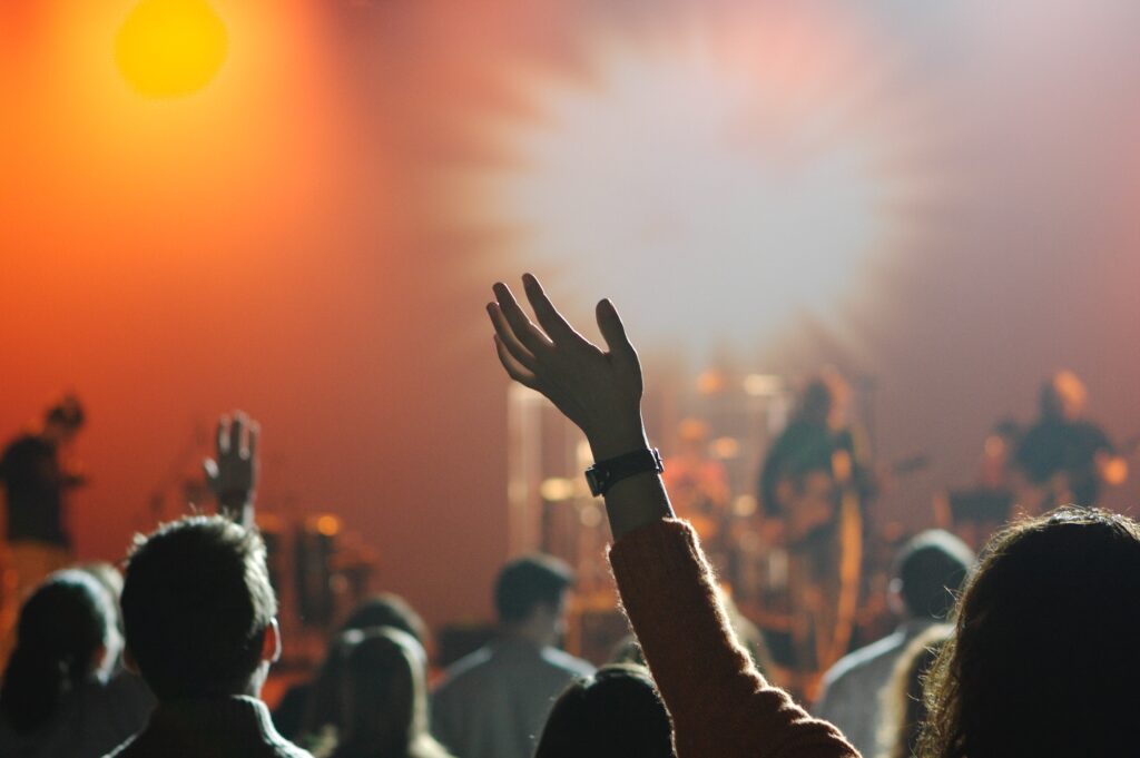 Concert-goers raising hands in worship