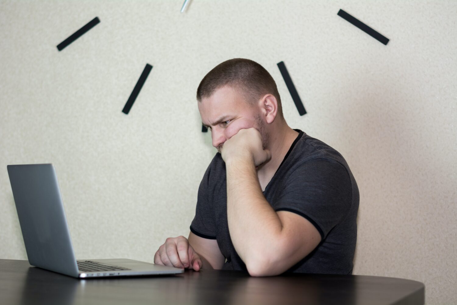 Frustrated man reading something online, feeling confused